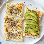 Keto Cottage Cheese Flatbread beautifully plated with avocado, cheese, and fresh herbs, surrounded by dietary supplements and fresh vegetables.