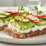 Photorealistic image of high-protein toast with creamy mashed avocado, cottage cheese, and colorful garnishes on a marble countertop